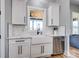 Bright kitchen showcasing white cabinets, farmhouse sink, and stainless steel dishwasher beneath a window at 805 Tirzah Rd, York, SC 29745