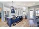 A stylish kitchen features a blue island with seating, pendant lights, and stainless steel appliances at 805 Tirzah Rd, York, SC 29745