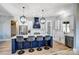 A spacious kitchen features a blue island with bar stool seating and stainless steel appliances at 805 Tirzah Rd, York, SC 29745