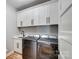A well-equipped laundry room features modern appliances, white cabinets, and a sink at 805 Tirzah Rd, York, SC 29745