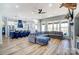 Open concept living room with a large gray sectional sofa, and a kitchen island with seating at 805 Tirzah Rd, York, SC 29745