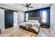 Spacious main bedroom with a sliding barn door, accent wall, and wood-look flooring at 805 Tirzah Rd, York, SC 29745