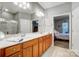 Bright bathroom with a double vanity, large mirror and a view to the bedroom at 9005 Smokey Hill Ln, Indian Land, SC 29707