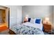 Comfortable bedroom with blue accents, including soft pillows and a lamp-lit nightstand, next to the ensuite door at 9005 Smokey Hill Ln, Indian Land, SC 29707