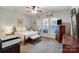 Inviting bedroom features neutral colors, plush carpet, and natural light from multiple windows at 9005 Smokey Hill Ln, Indian Land, SC 29707