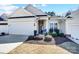 Charming single-story home featuring a well-manicured lawn, front porch, and attached two-car garage at 9005 Smokey Hill Ln, Indian Land, SC 29707