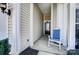 Close-up of a welcoming front porch featuring a comfortable rocking chair and stylish columns at 9005 Smokey Hill Ln, Indian Land, SC 29707