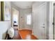Hallway with a storage bench and wall art, leading to the front door and bedroom at 9005 Smokey Hill Ln, Indian Land, SC 29707