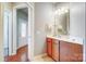 Hallway with a half bath vanity on the right and an entry door visible to the left, with hardwood floors at 9005 Smokey Hill Ln, Indian Land, SC 29707