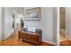 Inviting hallway with wooden floors, a decorative bench, and access to other rooms at 9005 Smokey Hill Ln, Indian Land, SC 29707