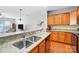 Modern kitchen features stainless steel sink, granite counters, and wood cabinets at 9005 Smokey Hill Ln, Indian Land, SC 29707