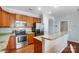 Well-lit kitchen features stainless steel appliances, granite countertops, and wood cabinets at 9005 Smokey Hill Ln, Indian Land, SC 29707