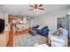 Cozy living room featuring a blue sofa, area rug, and open layout to the kitchen and dining area at 9005 Smokey Hill Ln, Indian Land, SC 29707