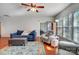Bright living room with a blue sofa, gray armchair, area rug, and natural light from large windows at 9005 Smokey Hill Ln, Indian Land, SC 29707