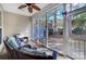 Relaxing screened-in porch with wicker furniture, ceiling fan, and view of the landscaped backyard at 9005 Smokey Hill Ln, Indian Land, SC 29707