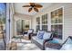 Inviting screened porch with wicker seating, ceiling fan, and slider doors to the interior at 9005 Smokey Hill Ln, Indian Land, SC 29707