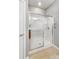 Clean, modern glass-enclosed shower with built-in shelves and accessibility handrail at 9005 Smokey Hill Ln, Indian Land, SC 29707