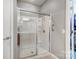 Clean, modern glass-enclosed shower with built-in shelves and accessibility handrail at 9005 Smokey Hill Ln, Indian Land, SC 29707