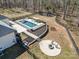 Aerial view of a fenced in backyard, with a private pool, hot tub, playground, and firepit at 9260 Ahavah Ln, Indian Trail, NC 28079