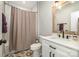 Bathroom featuring white subway tile shower and vanity with decorative floor tile at 9260 Ahavah Ln, Indian Trail, NC 28079