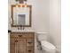 Half bathroom with white countertops, wood cabinet and vanity, and light fixture at 9260 Ahavah Ln, Indian Trail, NC 28079