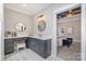 Bathroom vanity with dual round mirrors, quartz countertop, and grey cabinets at 9260 Ahavah Ln, Indian Trail, NC 28079