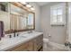 Bathroom featuring dual sinks, white countertop, and a wood framed mirror at 9260 Ahavah Ln, Indian Trail, NC 28079