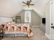 Bedroom with a ceiling fan, a window, and a cozy quilt on the bed at 9260 Ahavah Ln, Indian Trail, NC 28079