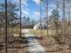 Wide shot of a two-story home with beautiful sky and a long gravel driveway at 9260 Ahavah Ln, Indian Trail, NC 28079