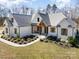 Beautiful home with painted brick and a wooden porch with nice landscaping at 9260 Ahavah Ln, Indian Trail, NC 28079