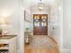 Bright foyer featuring hardwood floors, decorative rug, double doors, and elegant decor at 9260 Ahavah Ln, Indian Trail, NC 28079