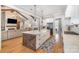 Bright and airy kitchen boasts a large island, farmhouse sink, stainless steel appliances, and an open design with living area at 9260 Ahavah Ln, Indian Trail, NC 28079
