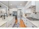 This kitchen showcases a bright, airy design with stainless steel appliances, a farmhouse sink, and hardwood floors at 9260 Ahavah Ln, Indian Trail, NC 28079