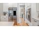 The kitchen features stainless steel appliances, including a refrigerator and double oven, with hardwood floors at 9260 Ahavah Ln, Indian Trail, NC 28079