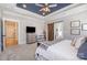 The primary suite features a tray ceiling and plush carpet; ensuite bathroom through a barn door at 9260 Ahavah Ln, Indian Trail, NC 28079