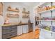 Butler's pantry with open shelving, wooden countertops, gray cabinets, and stainless steel mini refrigerator at 9260 Ahavah Ln, Indian Trail, NC 28079