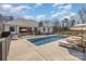 Backyard showcasing a sparkling pool with stone trim and comfortable lounge chairs at 9260 Ahavah Ln, Indian Trail, NC 28079