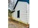 Side view of the house with blue trim window, siding, and partial brick foundation visible at 981 15Th St # 16, Lancaster, SC 29720
