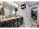 Modern bathroom featuring a double sink vanity with granite countertop, storage, and closet at 10379 Black Locust Ln, Charlotte, NC 28215