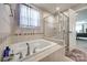 Luxurious bathroom with a soaking tub, separate shower, and stylish fixtures, offering a spa-like experience at 10379 Black Locust Ln, Charlotte, NC 28215