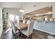 Bright dining area featuring a wooden table, seating for six, and an open view to the kitchen at 10379 Black Locust Ln, Charlotte, NC 28215