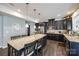 Modern kitchen with stainless steel appliances, granite countertops, a large island, and dark wood cabinets at 10379 Black Locust Ln, Charlotte, NC 28215