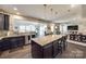 Open-concept kitchen with an oversized island that flows into the dining and living areas, perfect for entertaining at 10379 Black Locust Ln, Charlotte, NC 28215
