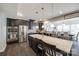 Modern kitchen featuring stainless steel appliances, granite countertops, a large island, and dark wood cabinets at 10379 Black Locust Ln, Charlotte, NC 28215