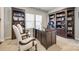 Well-lit home office with built-in bookshelves and a large desk for a productive workspace at 10379 Black Locust Ln, Charlotte, NC 28215