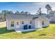 This backyard features a concrete patio with a grill and ample green space at 1076 Westminster Dr, Lancaster, SC 29720