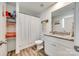Bathroom with a granite countertop vanity, a large mirror, and a shower with white curtain at 1076 Westminster Dr, Lancaster, SC 29720