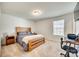 Bedroom with a wooden bed frame, work station, and a window that provides natural light at 1076 Westminster Dr, Lancaster, SC 29720