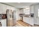 Bright kitchen featuring stainless steel refrigerator and updated cabinets at 1076 Westminster Dr, Lancaster, SC 29720