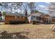 Brick home showcasing a spacious backyard and a sunroom, perfect for outdoor entertaining at 1120 Crestview Ave, Salisbury, NC 28144
